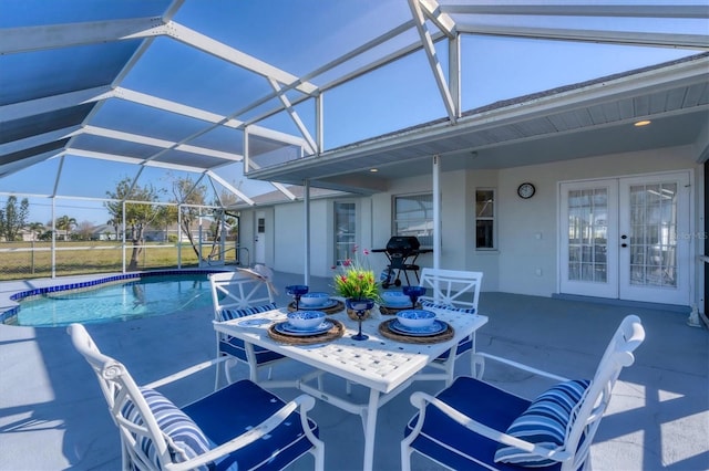 sunroom featuring a pool and french doors