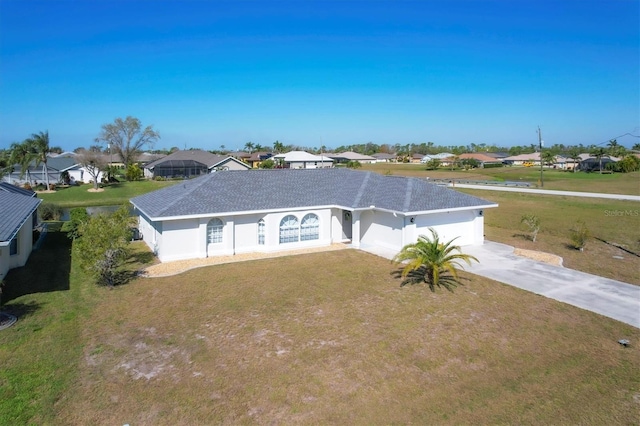 view of front of home with a front yard and a garage