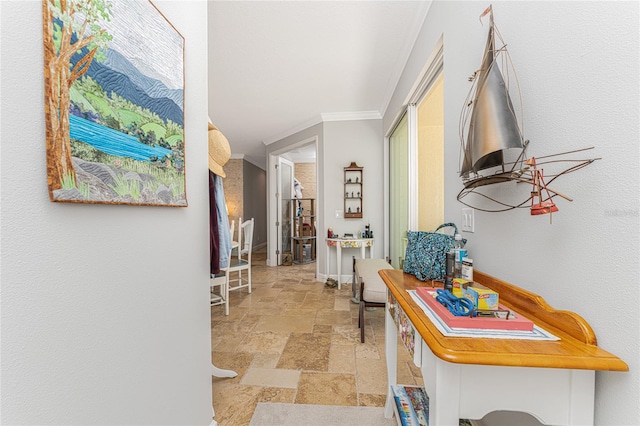 hall with ornamental molding and light tile floors