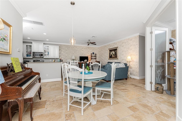 tiled dining space featuring crown molding and ceiling fan