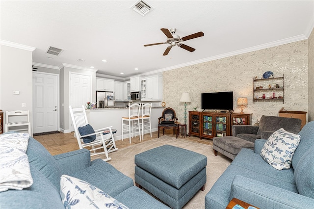 tiled living room featuring ceiling fan and crown molding