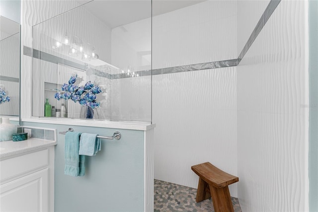 bathroom featuring vanity, tile floors, and tiled shower