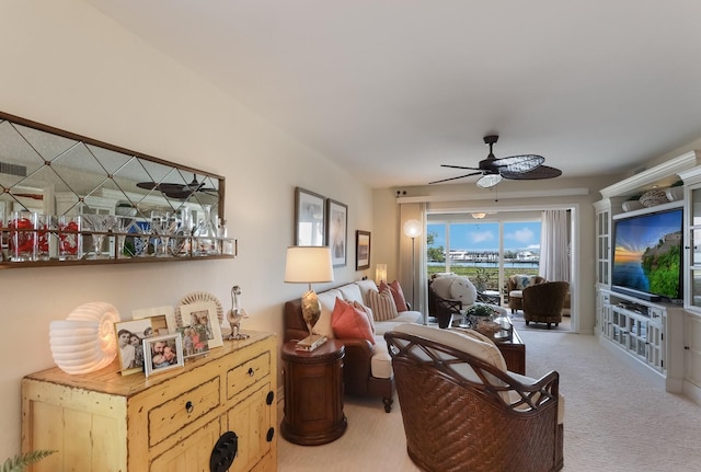 living room featuring light colored carpet and ceiling fan