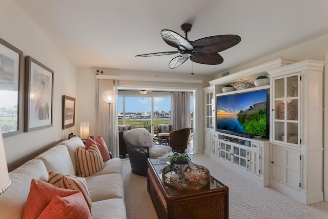 carpeted living room featuring ceiling fan