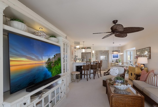 living room with light carpet and ceiling fan with notable chandelier