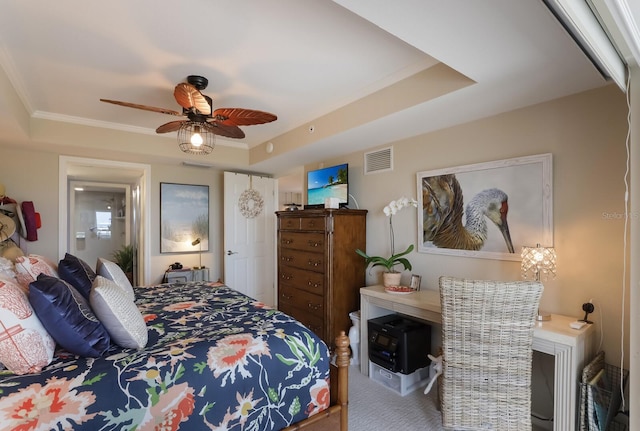 bedroom with a raised ceiling, crown molding, ceiling fan, and carpet