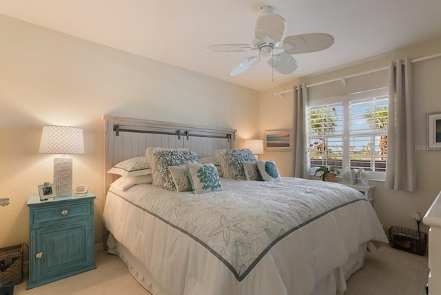 bedroom featuring light carpet and ceiling fan