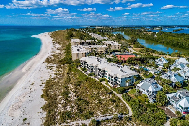 birds eye view of property with a beach view and a water view