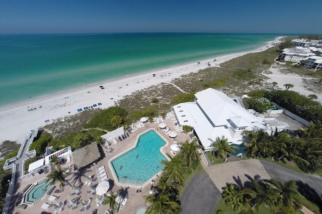 drone / aerial view featuring a water view and a view of the beach