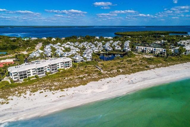 drone / aerial view featuring a beach view and a water view