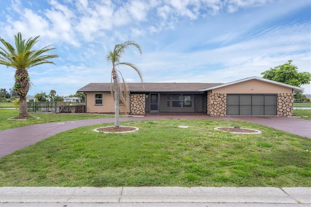 ranch-style home with a garage and a front lawn