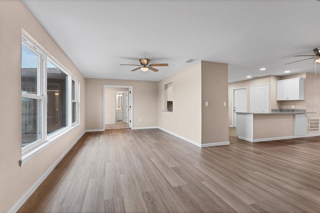 unfurnished living room featuring visible vents, baseboards, ceiling fan, wood finished floors, and recessed lighting