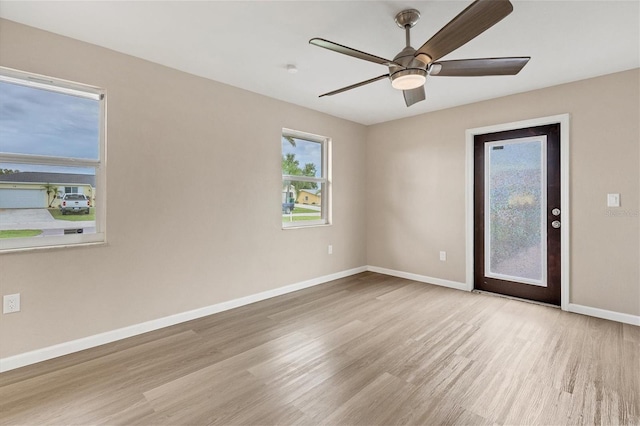 empty room featuring light hardwood / wood-style flooring and ceiling fan