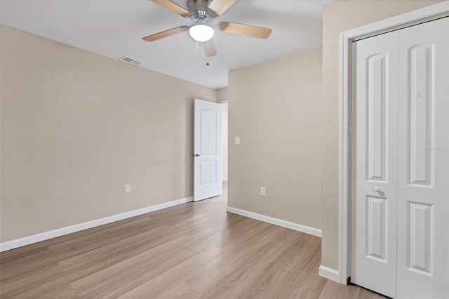 unfurnished bedroom with ceiling fan, light hardwood / wood-style floors, and a closet