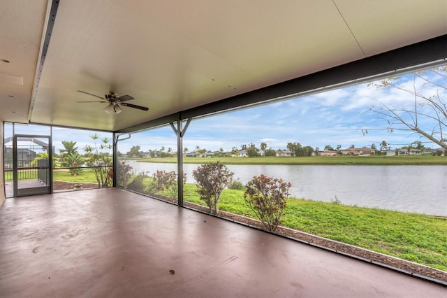 unfurnished sunroom with a water view and ceiling fan