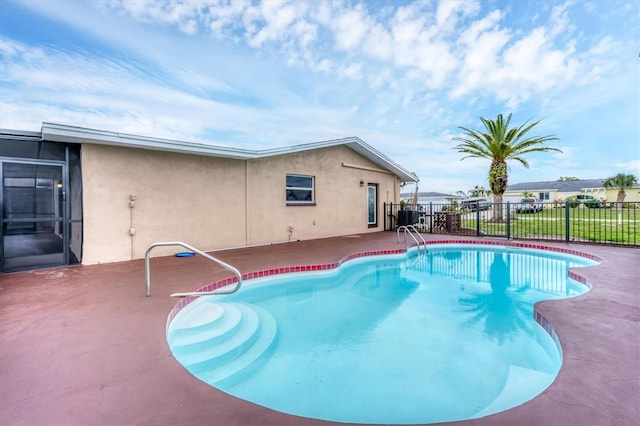 view of swimming pool featuring a patio area