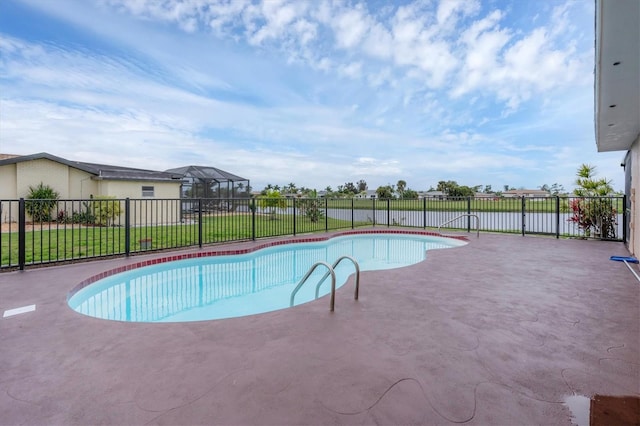 view of pool featuring a patio and a lawn