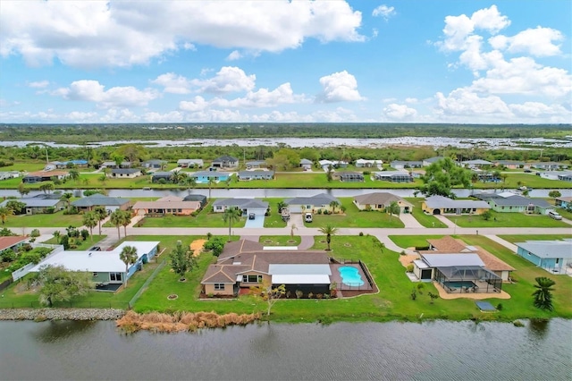 drone / aerial view featuring a residential view and a water view