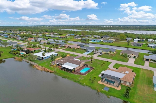 drone / aerial view featuring a water view and a residential view