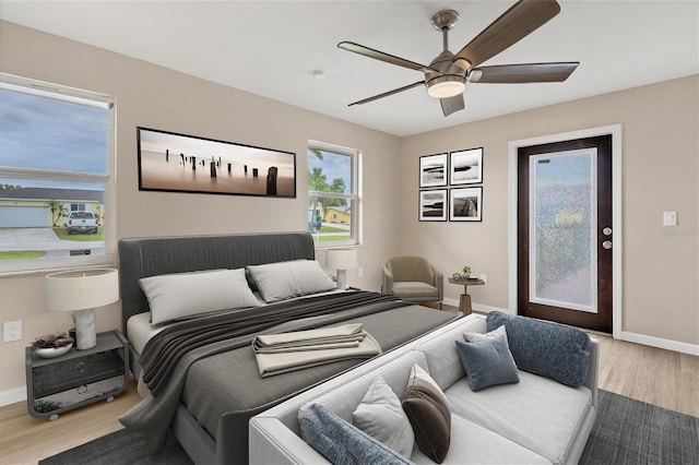 bedroom featuring a ceiling fan, access to outside, baseboards, and wood finished floors