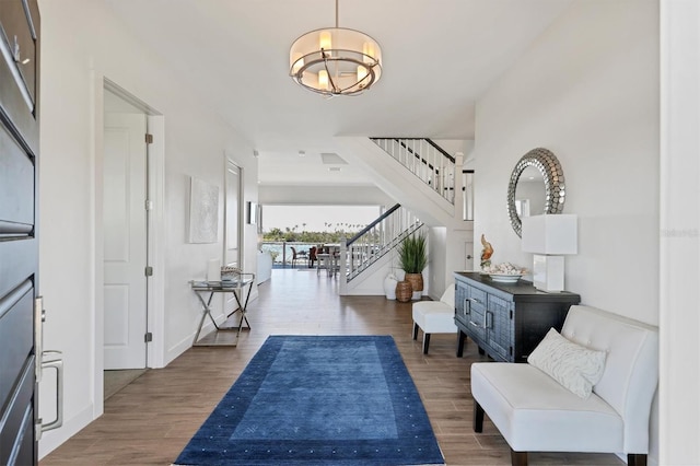 entryway featuring an inviting chandelier and dark hardwood / wood-style flooring