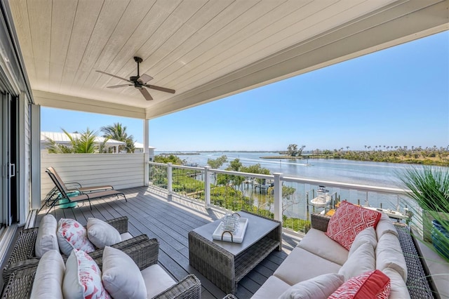 deck featuring a water view, outdoor lounge area, and ceiling fan