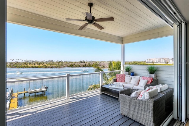 wooden deck with an outdoor hangout area, a water view, and ceiling fan