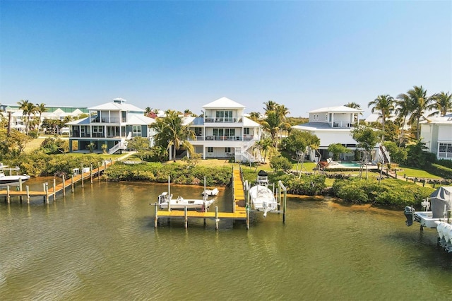 dock area with a water view and a balcony