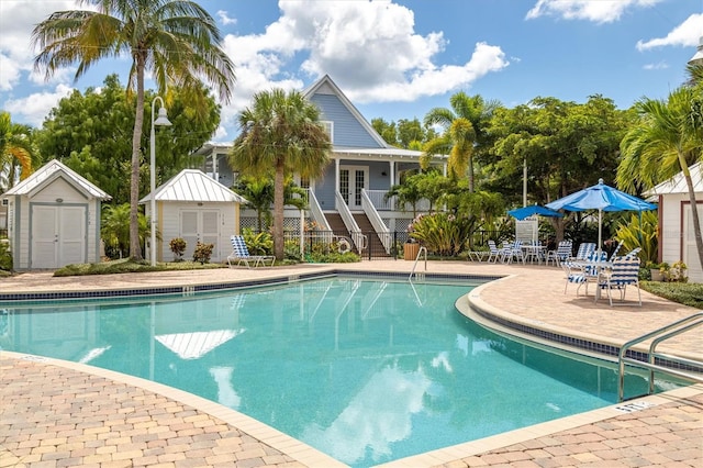 view of pool with a patio area and an outdoor structure