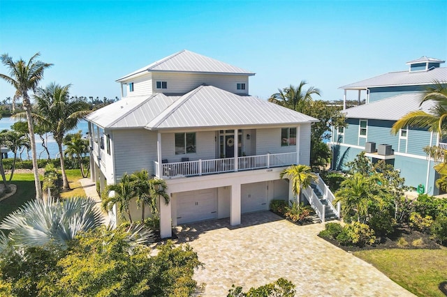 raised beach house featuring a garage