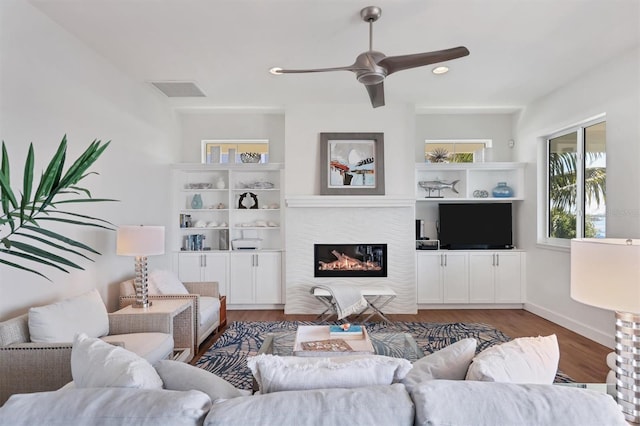 living room featuring wood-type flooring and ceiling fan