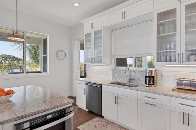 kitchen featuring backsplash, a healthy amount of sunlight, and appliances with stainless steel finishes