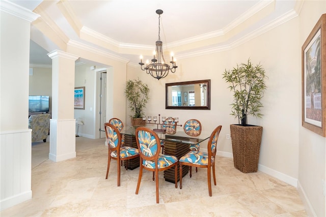 dining room featuring light tile floors, a tray ceiling, decorative columns, and a notable chandelier