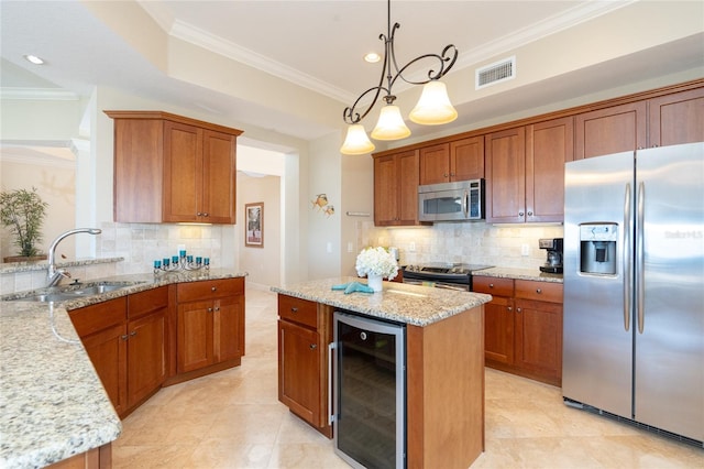 kitchen featuring pendant lighting, stainless steel appliances, a center island, beverage cooler, and backsplash