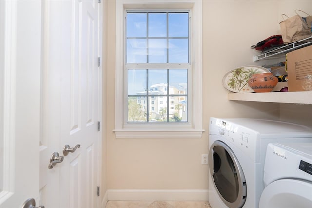 washroom featuring separate washer and dryer and light tile floors