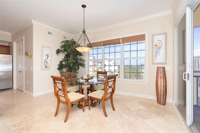 dining space with light tile floors and ornamental molding