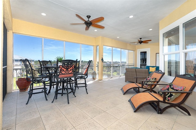 sunroom with plenty of natural light and ceiling fan