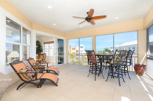 sunroom / solarium featuring ceiling fan