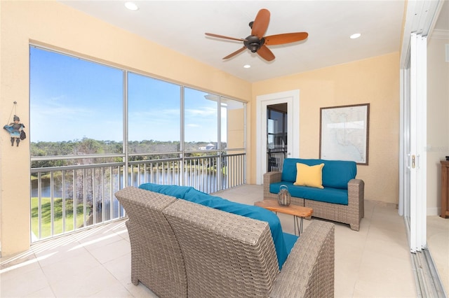 sunroom with a healthy amount of sunlight and ceiling fan