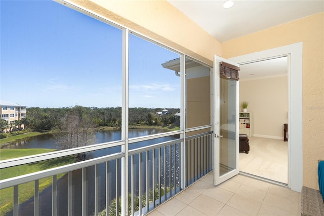 unfurnished sunroom featuring a water view