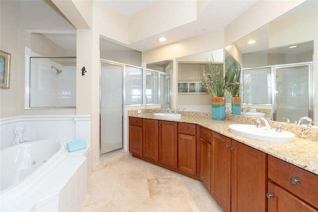 bathroom featuring shower with separate bathtub, tile floors, dual sinks, and large vanity