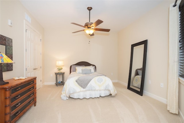 carpeted bedroom featuring a closet and ceiling fan