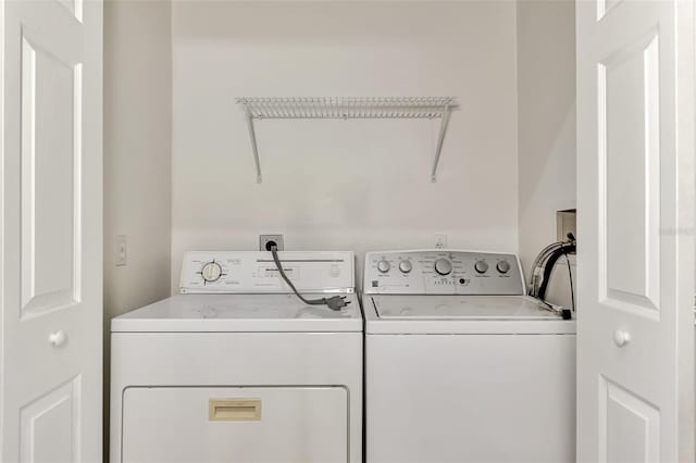 laundry room with hookup for a washing machine and washer and clothes dryer