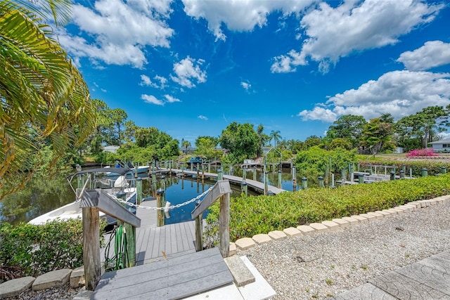 exterior space with a water view and a boat dock