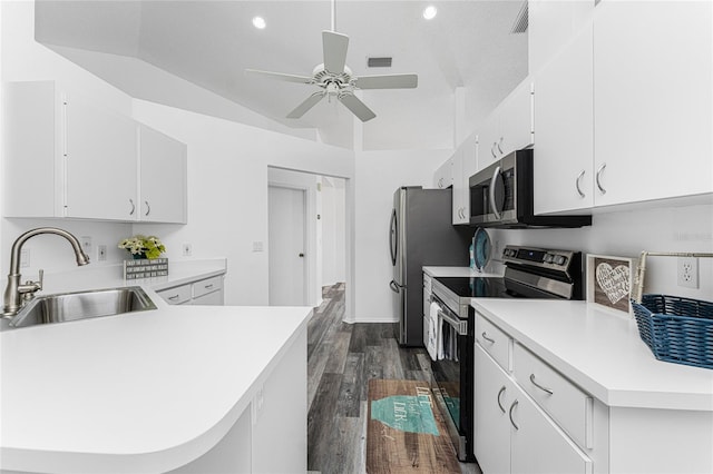 kitchen featuring white cabinets, appliances with stainless steel finishes, vaulted ceiling, and sink