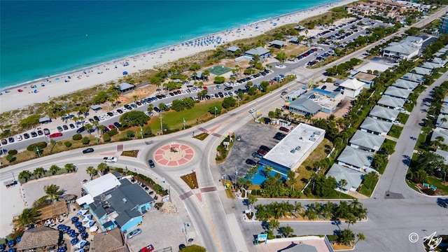 bird's eye view featuring a water view and a beach view