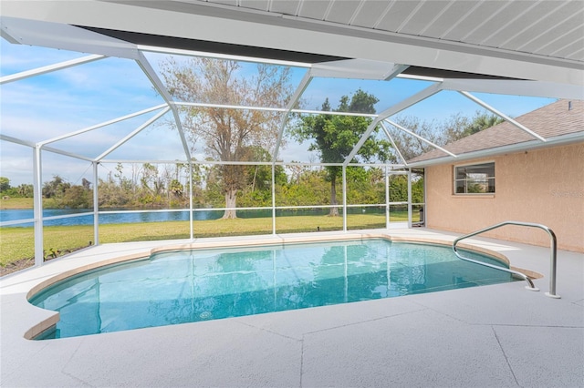 view of pool featuring a lawn, glass enclosure, and a water view