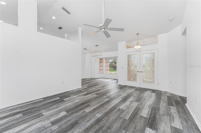 unfurnished living room featuring ceiling fan with notable chandelier, french doors, a textured ceiling, and dark wood-type flooring