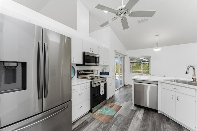 kitchen featuring stainless steel appliances, dark wood-type flooring, sink, pendant lighting, and white cabinets