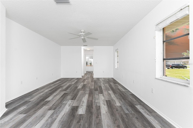 unfurnished living room featuring a textured ceiling, ceiling fan, and dark hardwood / wood-style floors